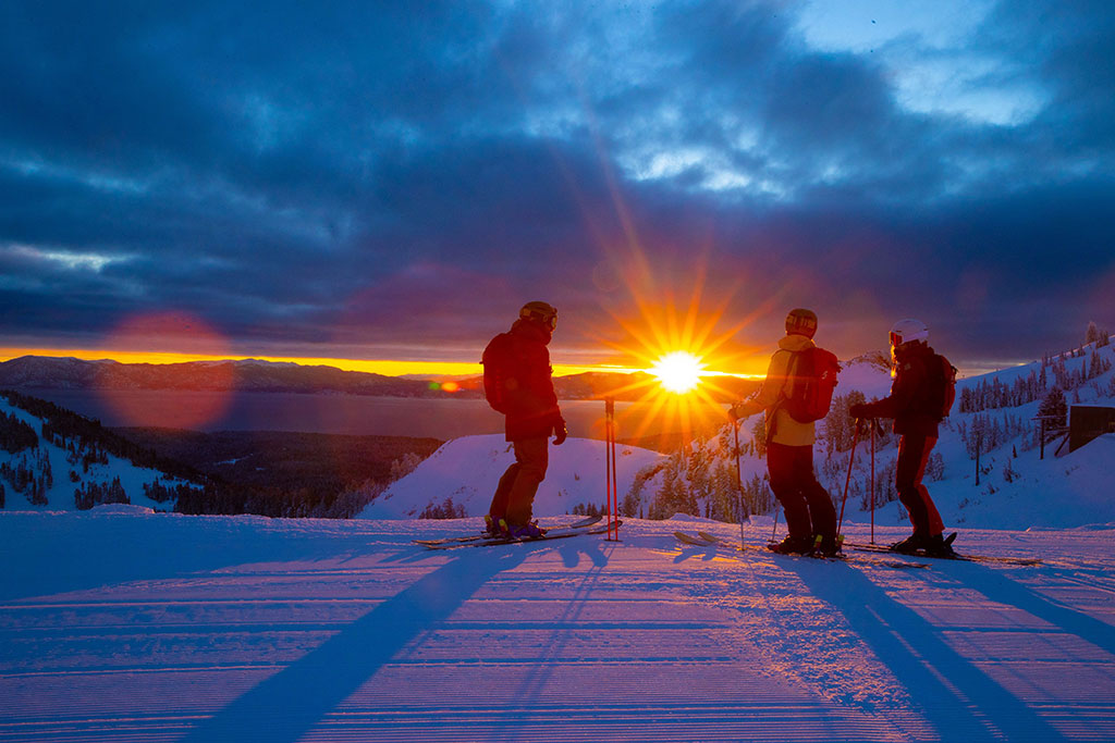 Two people skiing and sunset